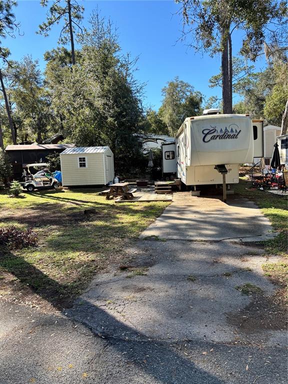 14348 Northeast 252nd Ct Road Fort McCoy, FL 32134 - Photo 8 of 51 a view of a house with backyard and trees