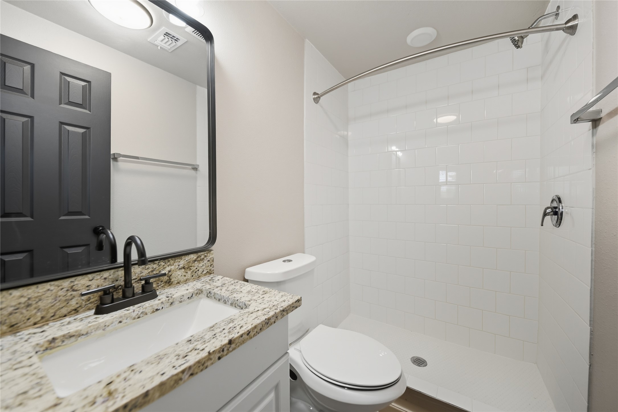9137 Conner Road Washington, TX 77880 - Photo 30 of 49 a bathroom with a granite countertop sink toilet a mirror and shower