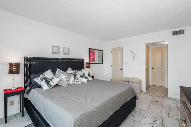 a bedroom with a bed and a lamp