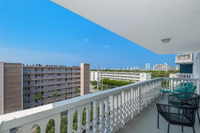 a view of a balcony with chair and city view