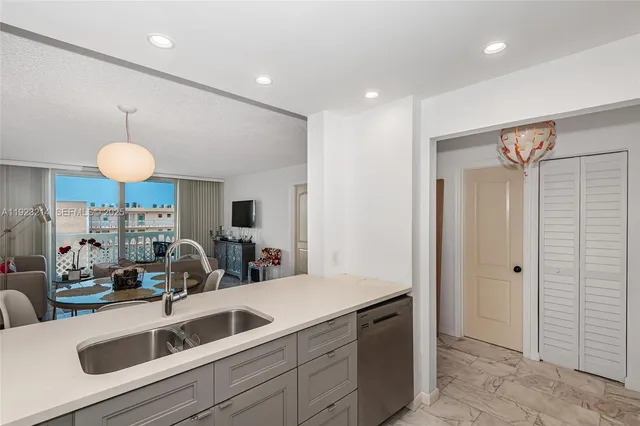 a view of a kitchen with a sink and a refrigerator