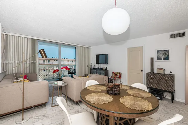 a living room with furniture and a mirror