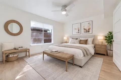 a bedroom with a bed and a window