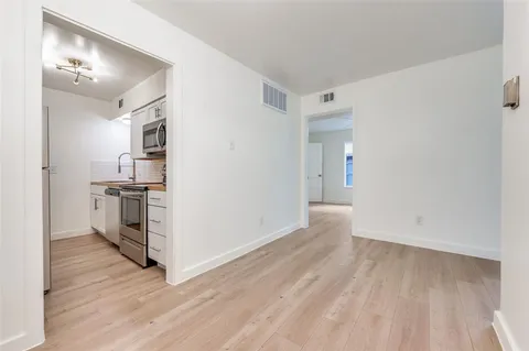 a view of kitchen and wooden floor