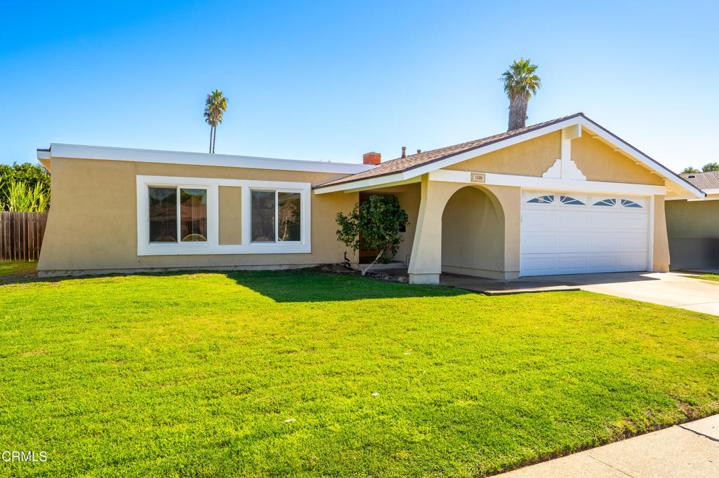 a view of a house with a backyard
