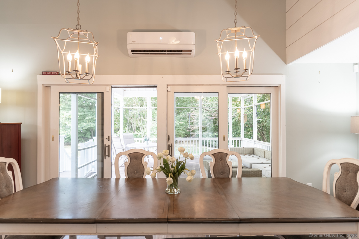 147 Pequot Avenue Groton, CT 06355 - Photo 10 of 39 a view of dining room and livingroom with furniture wooden floor a chandelier