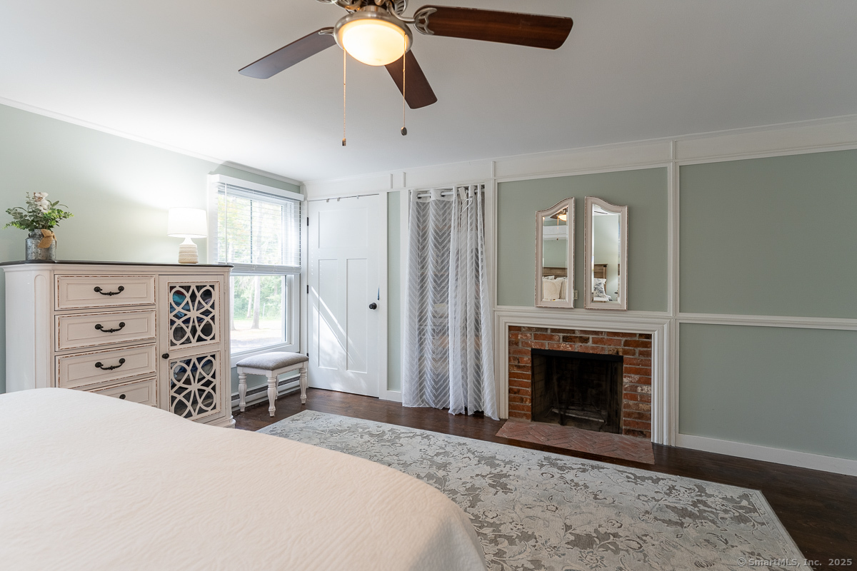 147 Pequot Avenue Groton, CT 06355 - Photo 24 of 39 a spacious bedroom with a bed and a fireplace