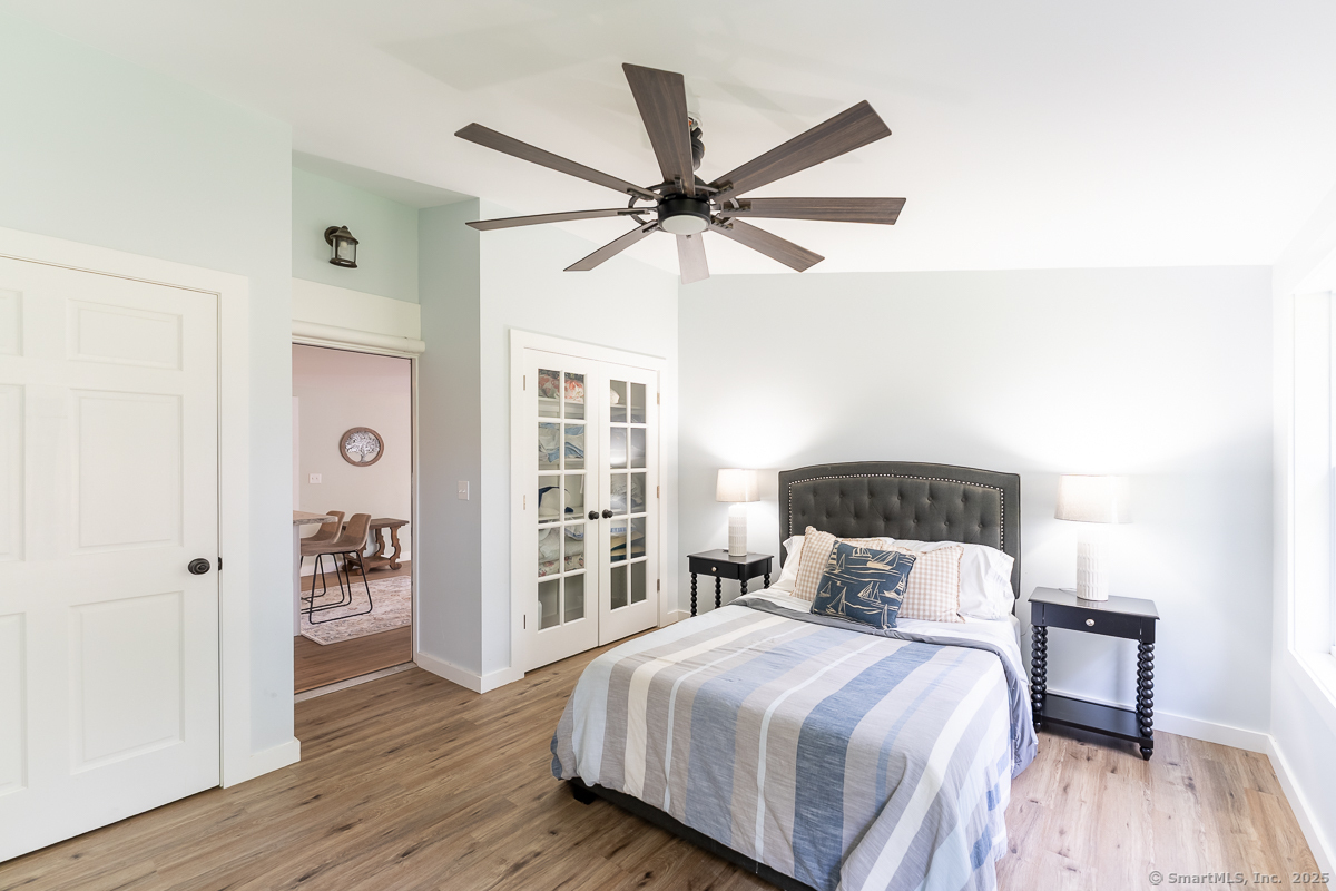 147 Pequot Avenue Groton, CT 06355 - Photo 29 of 39 a bedroom with a bed and wooden floor
