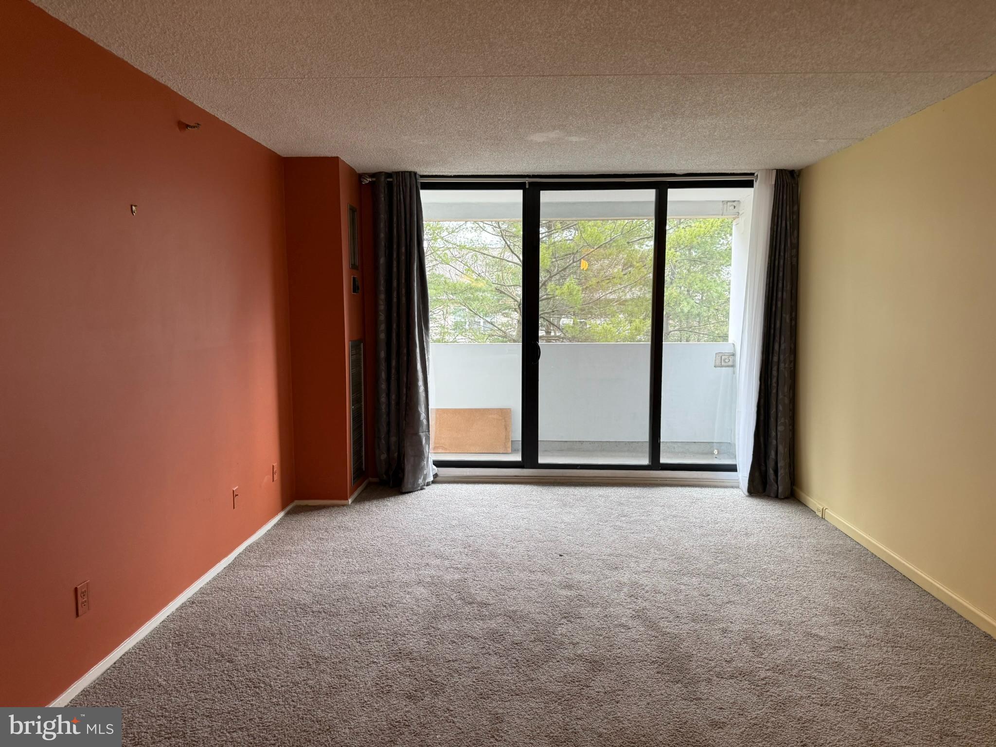 an empty room with large window