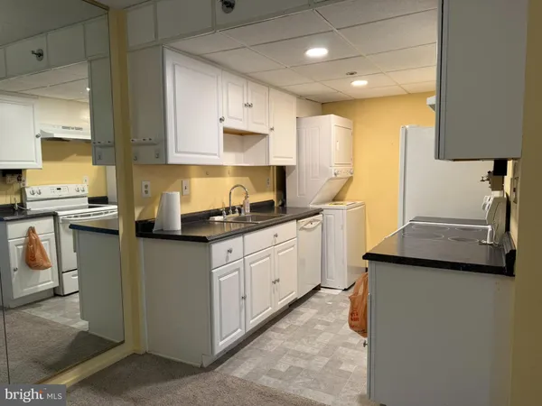 a kitchen with stainless steel appliances granite countertop a sink a stove and a refrigerator