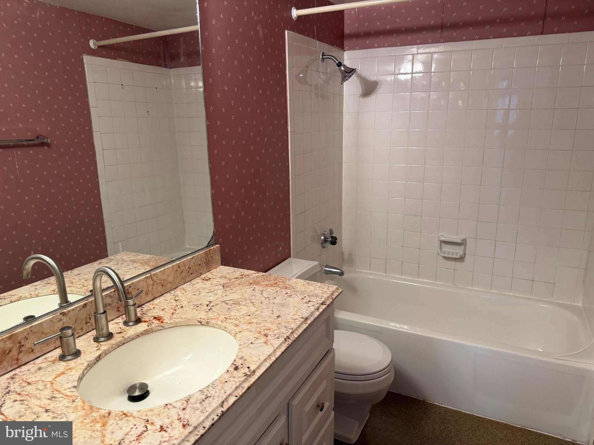5911 Edsall Road, Unit 601 Alexandria, VA 22304 - Photo 10 of 14 a bathroom with a granite countertop sink toilet and shower