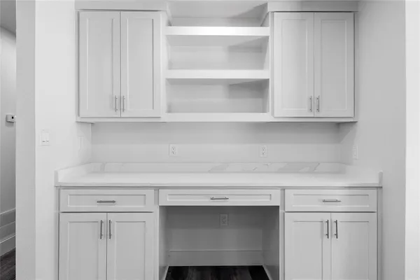 a view of white cabinets and a wooden floor