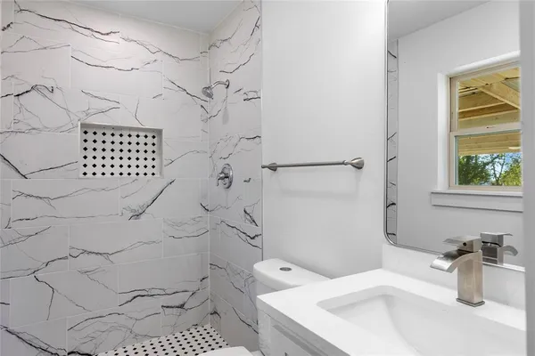 a bathroom with a sink toilet and shower