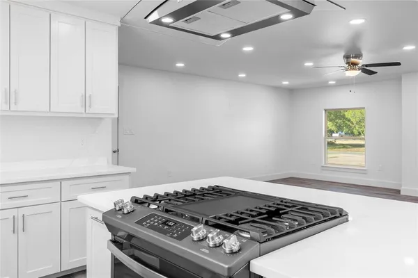 a stove top oven sitting inside of a kitchen