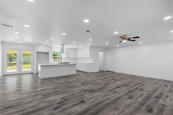 a view of an empty room with kitchen appliances and a kitchen view