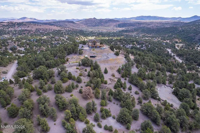 an aerial view of residential house and green field
