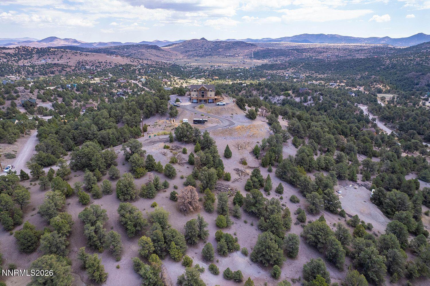an aerial view of residential house and green field