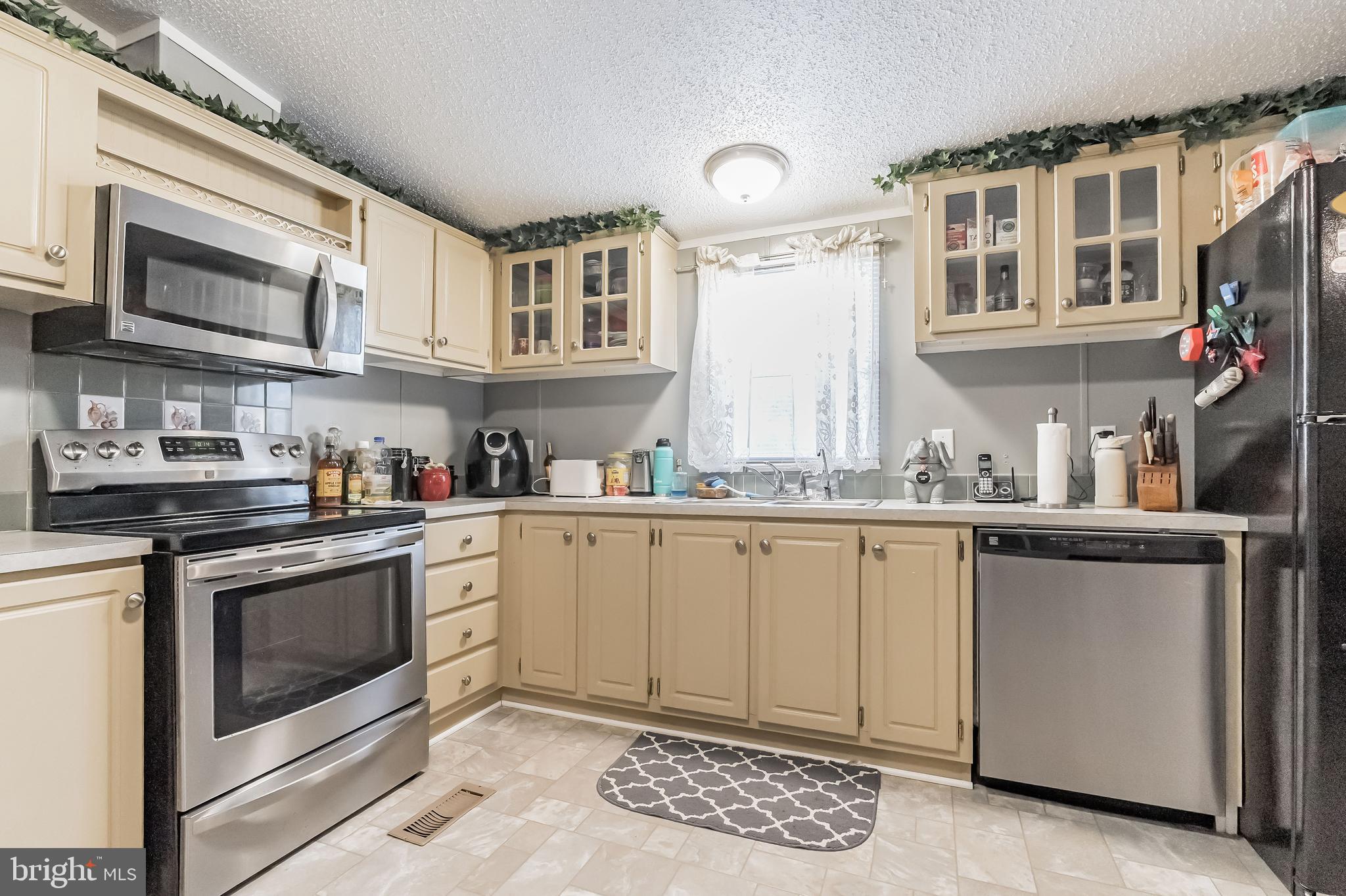 2705 Port Tobacco Road Nanjemoy, MD 20662 - Photo 14 of 14 a kitchen with stainless steel appliances granite countertop a stove a sink and a microwave