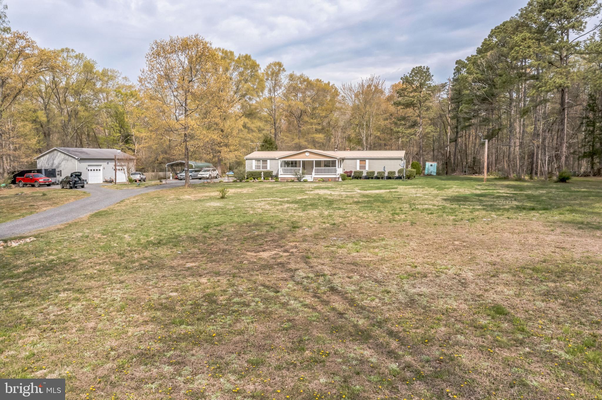2705 Port Tobacco Road Nanjemoy, MD 20662 - Photo 6 of 14 a front view of a house with a garden and trees