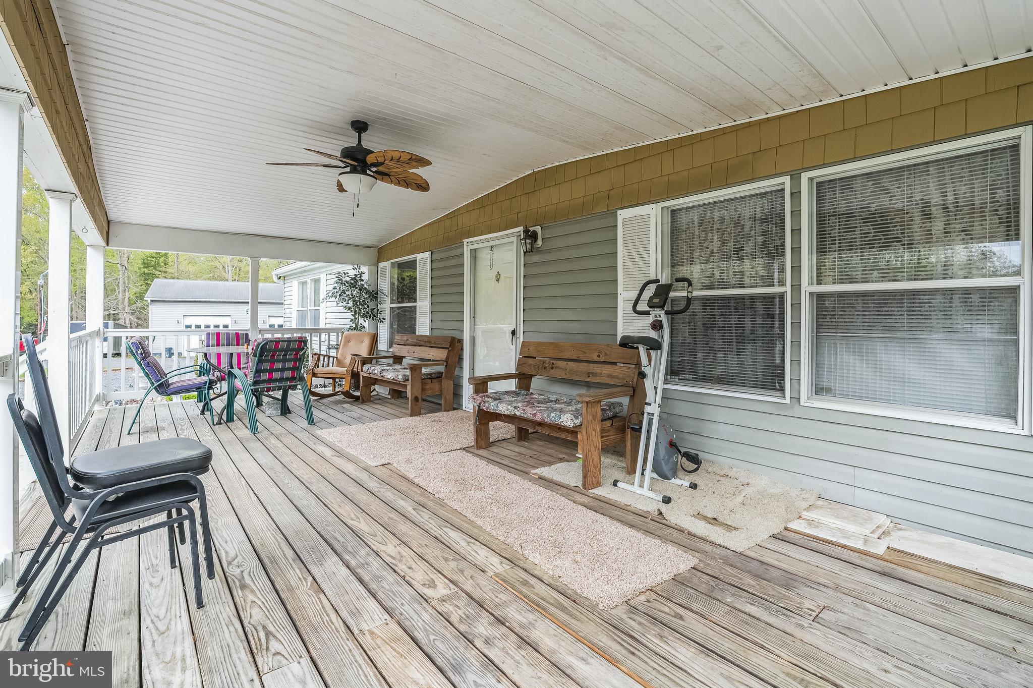 2705 Port Tobacco Road Nanjemoy, MD 20662 - Photo 8 of 14 a view of a patio with table and chairs with wooden floor and floor to ceiling window