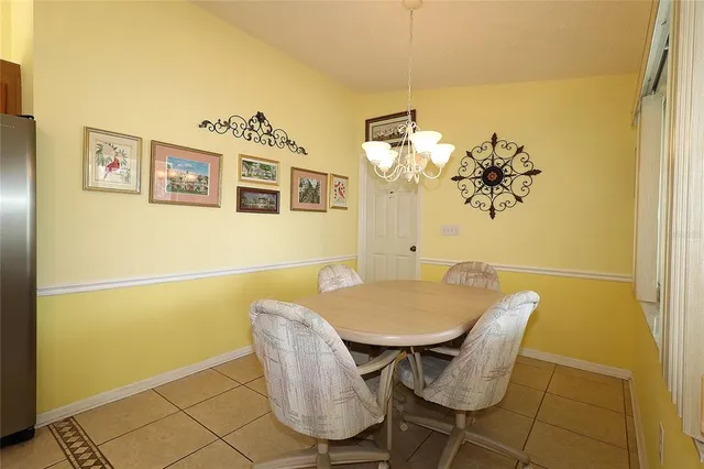 a view of a dining room with furniture and chandelier