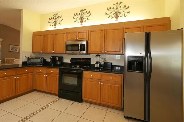 a kitchen with stainless steel appliances granite countertop a refrigerator sink and cabinets