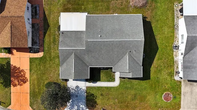 an aerial view of residential house with pool and yard