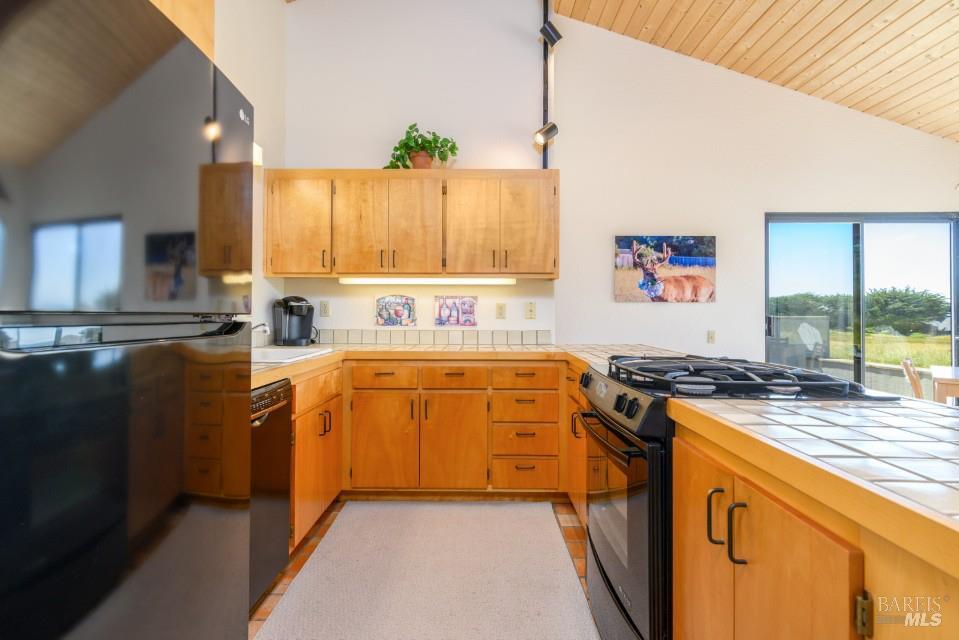 267 Sea Stack The Sea Ranch, CA 95497 - Photo 23 of 35 a kitchen with stainless steel appliances granite countertop a stove a sink and a microwave