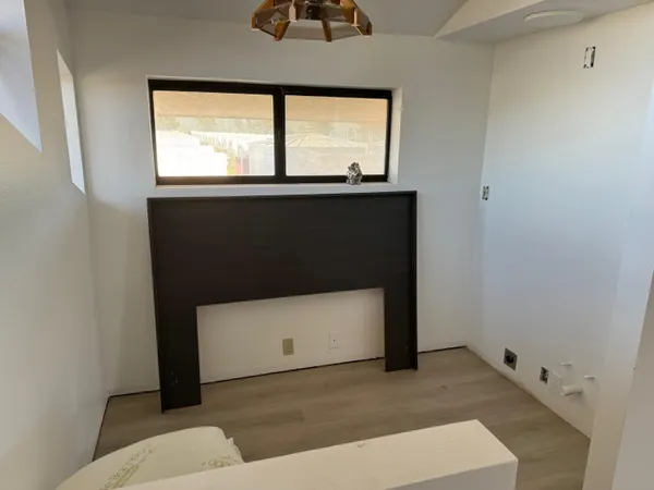 a bedroom with a bed and a couch