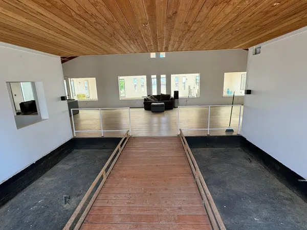 a view of a room with wooden floor