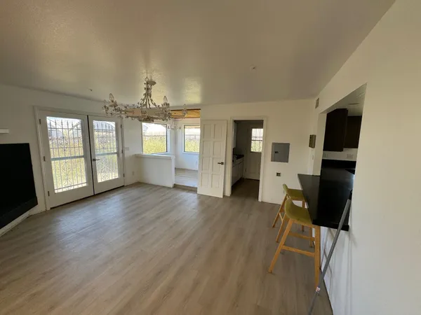 a living room with a bed furniture and a window