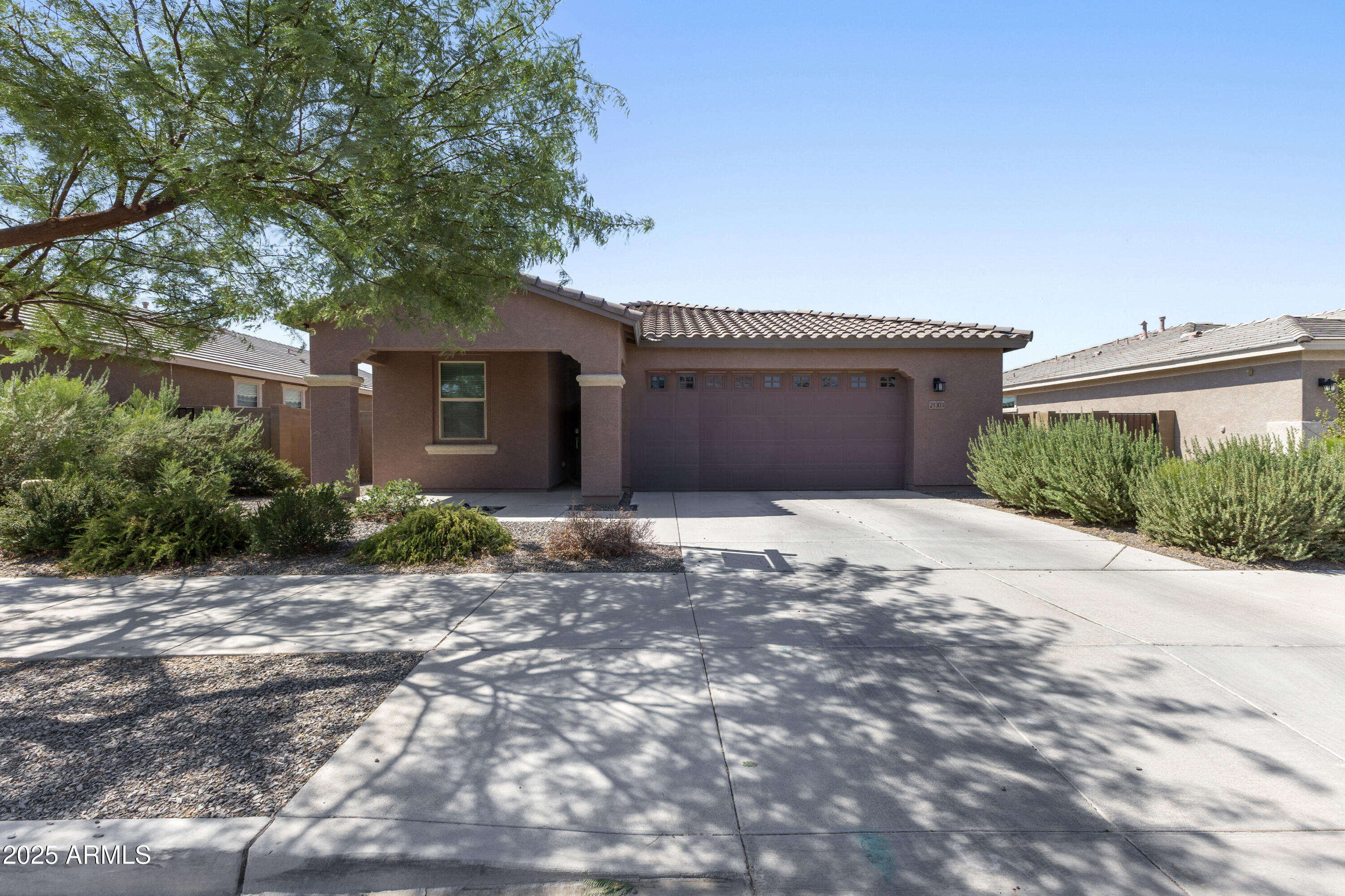 21303 East Estrella Road Queen Creek, AZ 85142 - Photo 1 of 32 a front view of a house with a yard