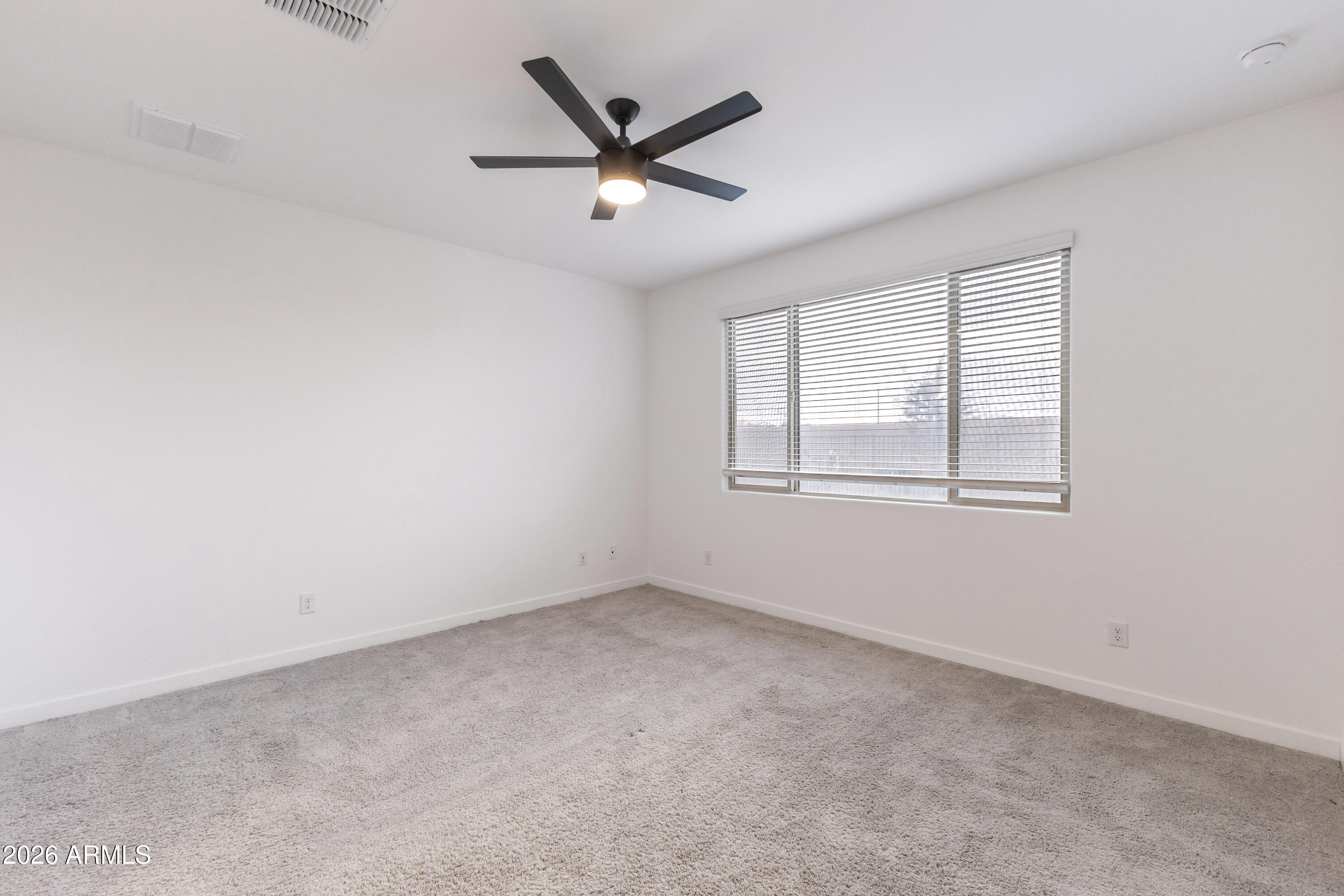 21303 East Estrella Road Queen Creek, AZ 85142 - Photo 16 of 32 an empty room with ceiling fan and windows