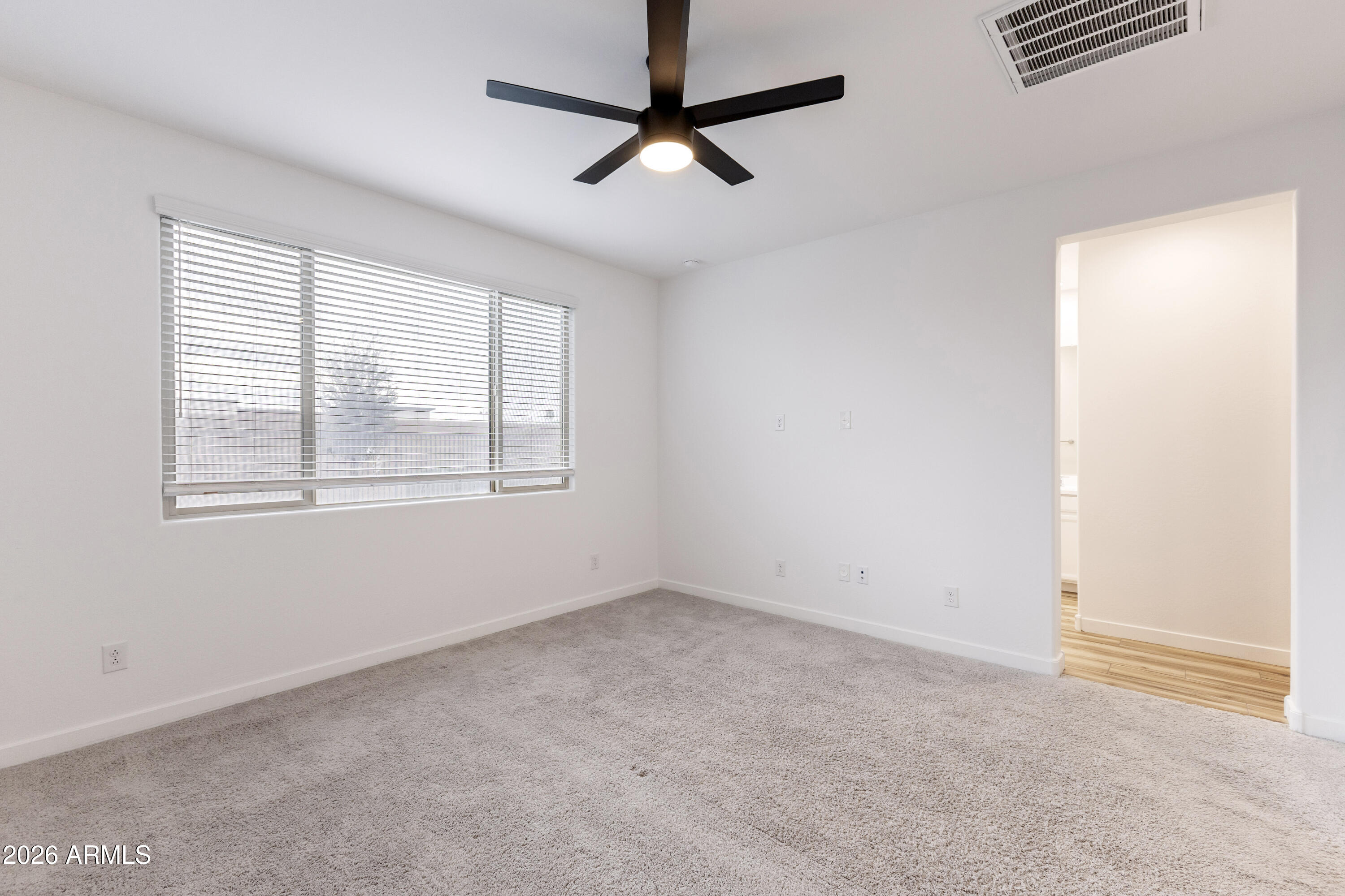 21303 East Estrella Road Queen Creek, AZ 85142 - Photo 17 of 32 a view of an empty room with a window