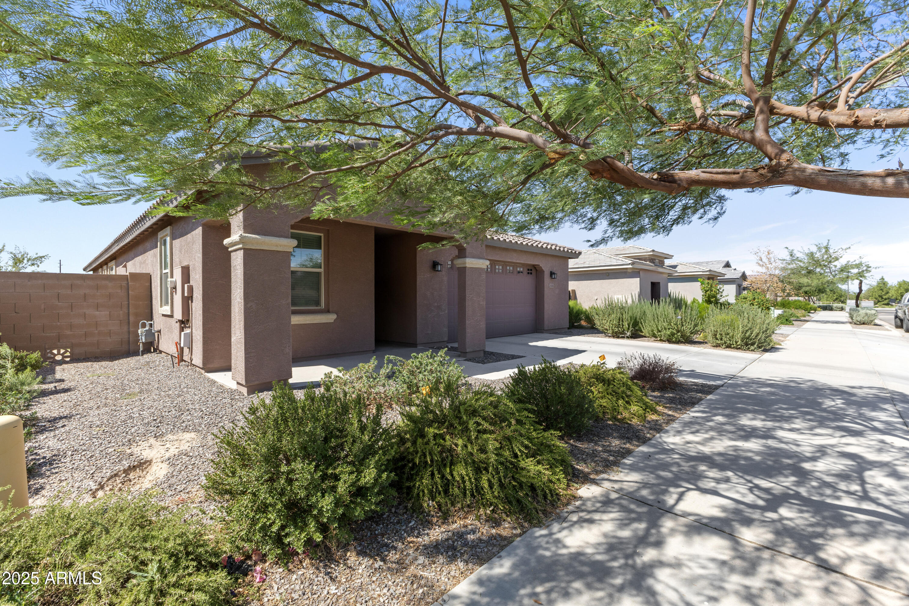 21303 East Estrella Road Queen Creek, AZ 85142 - Photo 2 of 32 a front view of a house with a yard and garage