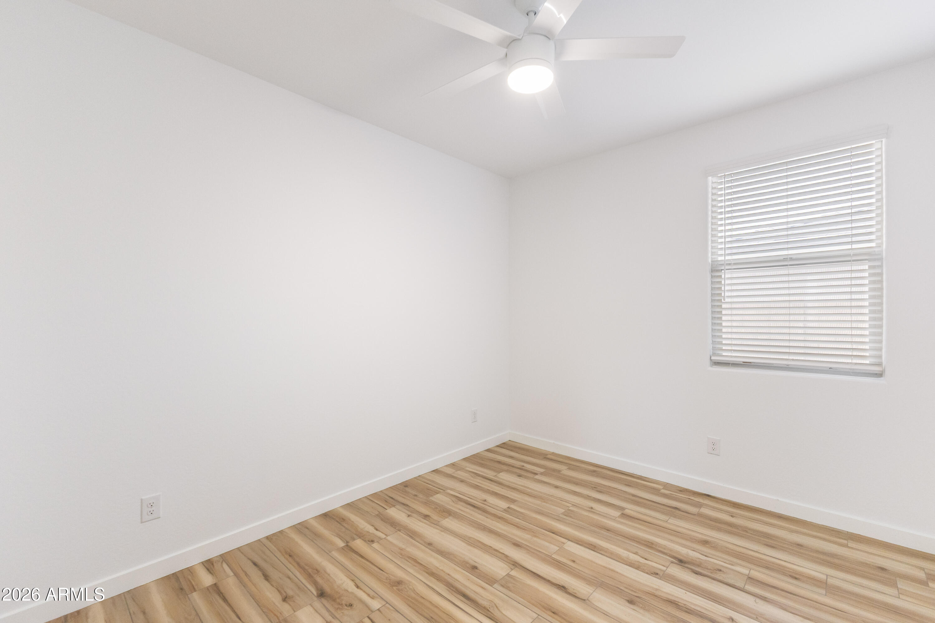 21303 East Estrella Road Queen Creek, AZ 85142 - Photo 22 of 32 an empty room with a window and chandelier fan