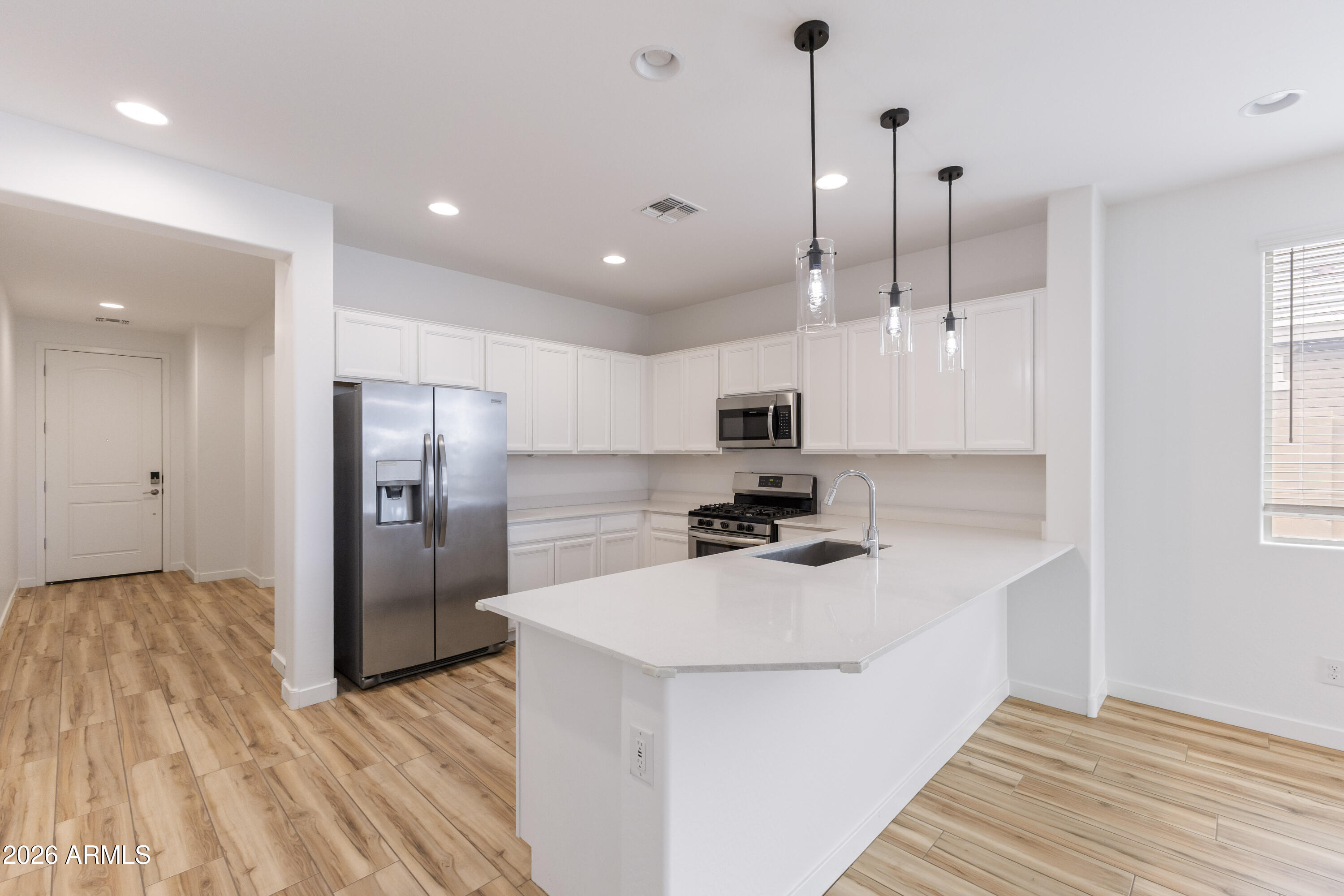21303 East Estrella Road Queen Creek, AZ 85142 - Photo 10 of 32 a kitchen with stainless steel appliances a refrigerator sink and microwave