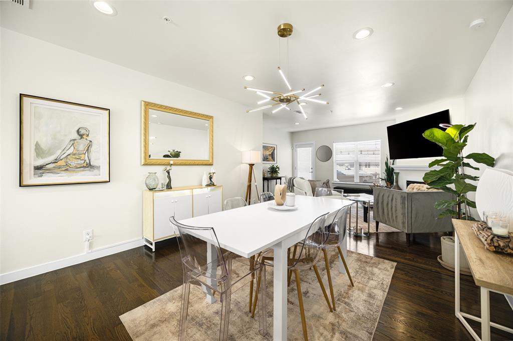 3922 Gilbert Avenue, Unit 214 Dallas, TX 75219 - Photo 7 of 27 Open-concept living area featuring dark wood-finish flooring, recessed lighting, a modern sputnik chandelier, and white baseboards