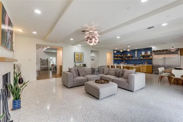 a living room with furniture and a chandelier