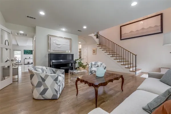 a living room with furniture couches and a flat screen tv