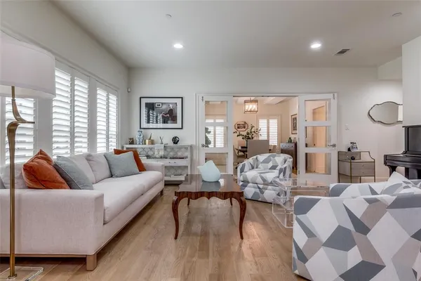 a living room with furniture wooden floor and a large window