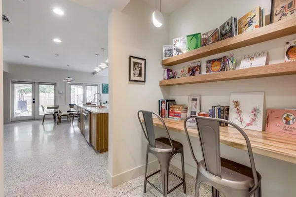 a dining room with furniture and a kitchen view