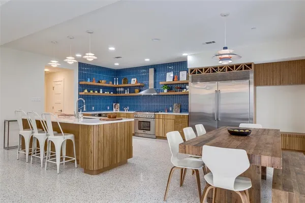 a living room with dining room and kitchen view