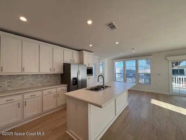 a kitchen with a sink stove and cabinets