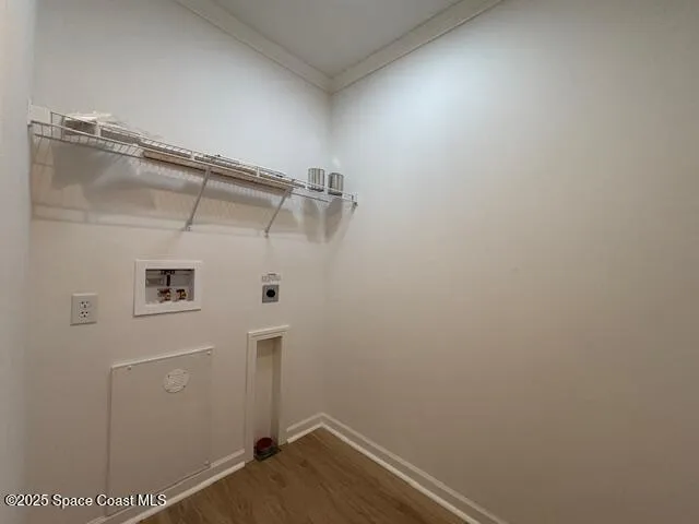 a view of an empty room with wooden floor and closet