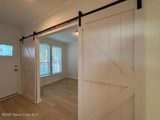 a view of an empty room and wooden floor
