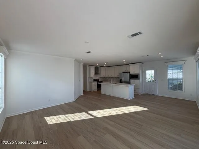 a view of a kitchen with a sink a refrigerator and a stove