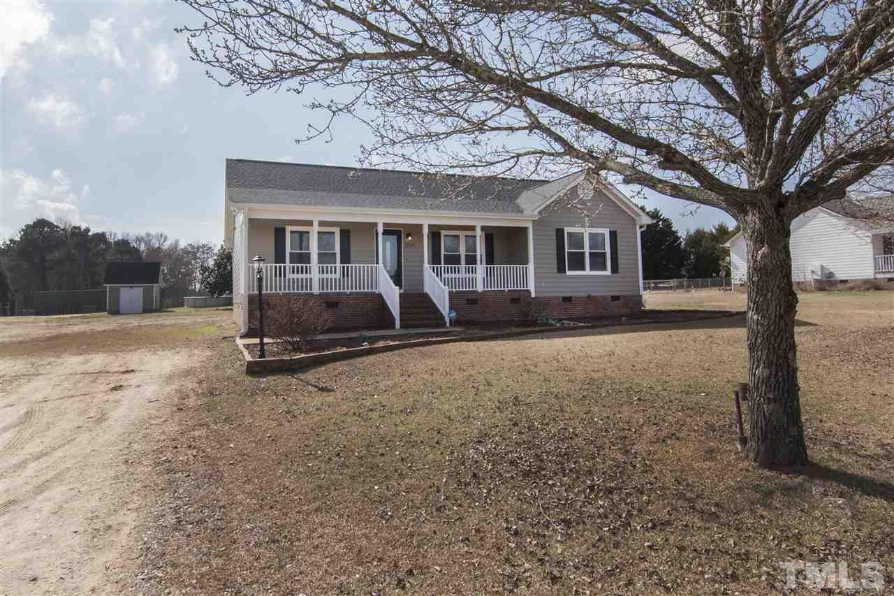 1849 Sanders Road Willow Spring, NC 27592 - Photo 1 of 25 a front view of a house with trees