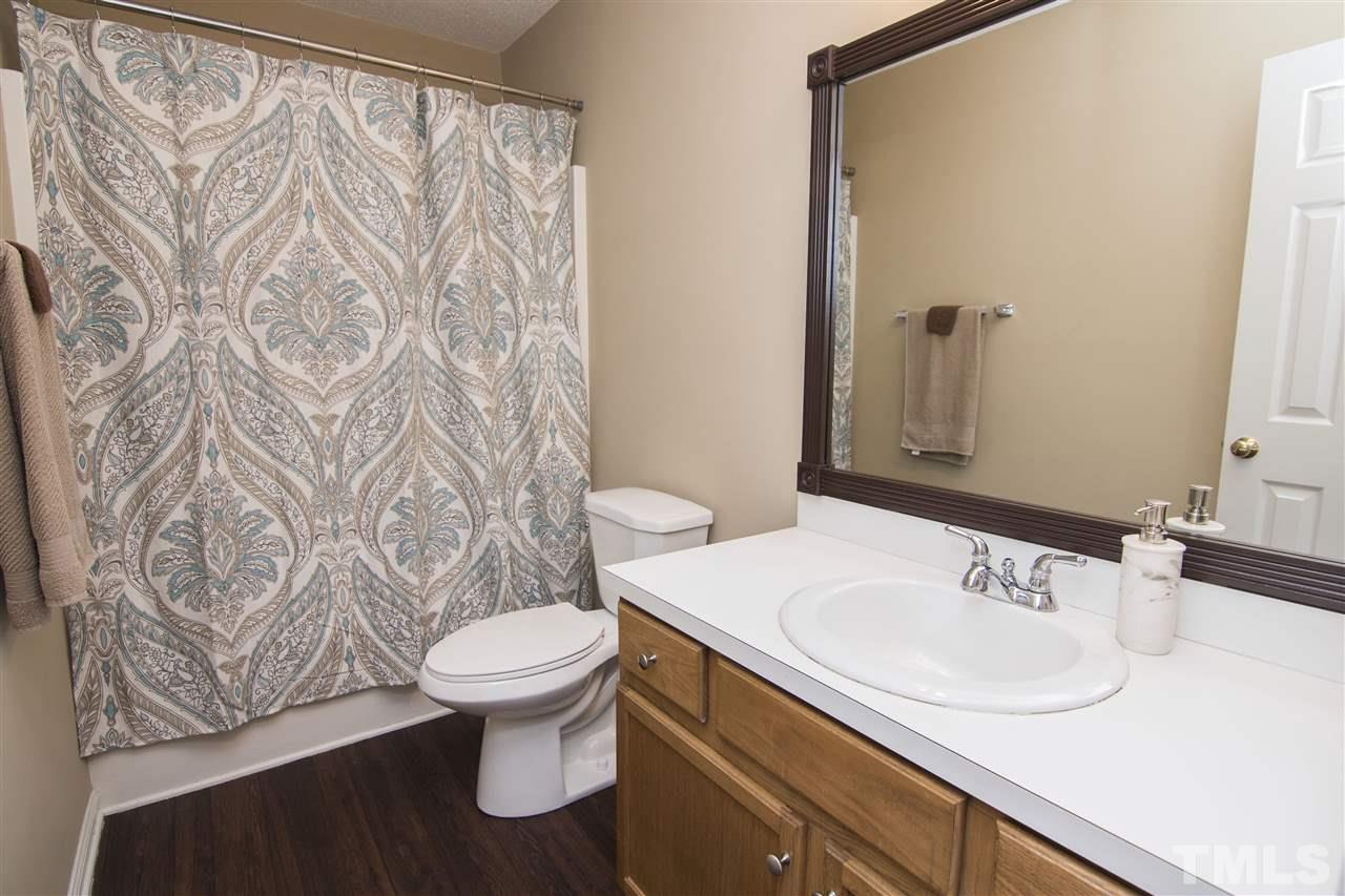 1849 Sanders Road Willow Spring, NC 27592 - Photo 13 of 25 a bathroom with a sink and a toilet