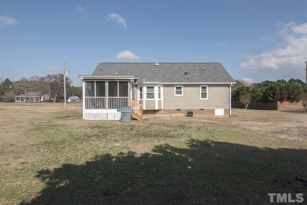 1849 Sanders Road Willow Spring, NC 27592 - Photo 23 of 25 a front view of a house with a garden